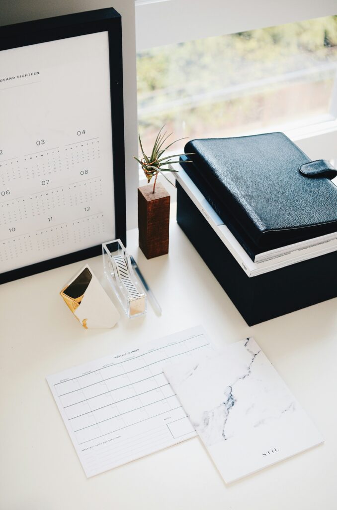 Bureau blanc avec des fournitures de bureau type calendrier, carnet de notes